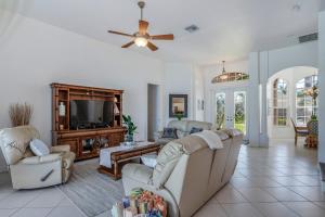 a living room with couches and a flat screen tv at Sable Retreat in Cape Coral