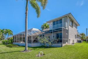 a house with a palm tree in front of it at Sable Retreat in Cape Coral