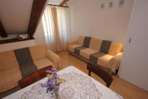 a living room with a couch and a table at Apartments by the sea Komiza, Vis - 8533 in Komiža