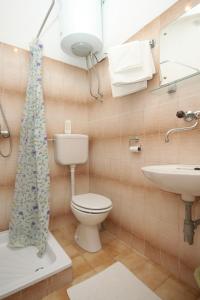 a bathroom with a toilet and a sink at Rooms by the sea Pasman - 8223 in Pašman