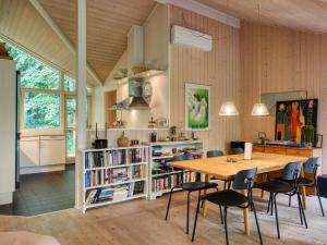 a kitchen and dining room with a table and chairs at Holiday home Vejby XXX in Vejby