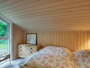 a bedroom with a bed and a wooden ceiling at Holiday home Vejby XXX in Vejby
