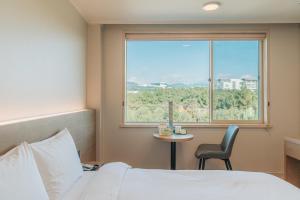 Postel nebo postele na pokoji v ubytování Bloom Hotel