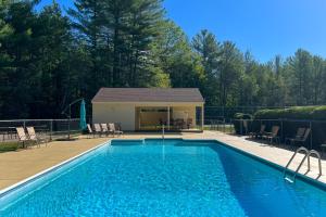 a swimming pool in front of a house at Cozy Conway Condo in Conway