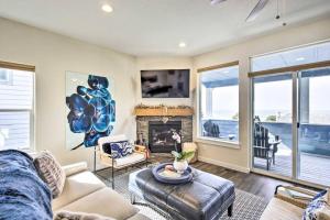 a living room with a couch and a fireplace at Modern Oregon Retreat w/ Deck, Hot Tub, Ocean View in Depoe Bay