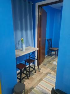 a table and chairs in a room with blue walls at bluenest apartment in Manila