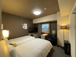 Voodi või voodid majutusasutuse Hotel Route Inn Mitsuke -Nakanoshima Mitsuke Inter- toas