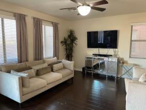 a living room with a couch and a flat screen tv at Luxury in Laveen in Phoenix