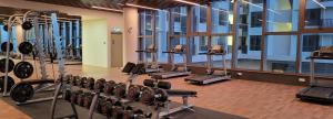 a gym with a row of treadmills and machines at Bali Residence Impian Raudah in Melaka