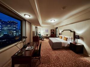 a hotel room with a bed and a large window at Imperial Hotel Tokyo in Tokyo