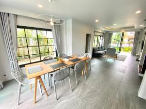a dining room with a table and chairs at The Retreat Ao nang Private Pool Villa in Ao Nang Beach