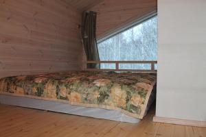 a bedroom with a bed in a room with a window at SResort Family Apartment in Imatra +32 photos