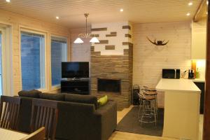 a living room with a couch and a fireplace at SResort Family Apartment in Imatra
