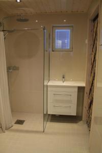 a bathroom with a shower and a sink at SResort Family Apartment in Imatra