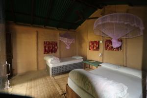 A bed or beds in a room at Wild Planet Eco Retreat