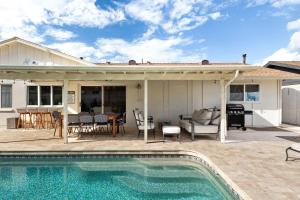a patio with a swimming pool and a house at South Scottsdale w/ Chef's Kitchen & Golf Nearby!! in Scottsdale