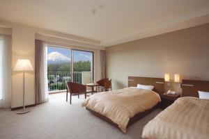 a hotel room with a bed and a view of a mountain at The Gran Resort Princess Fujikawaguchiko in Fujikawaguchiko