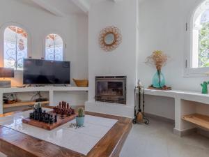 a living room with a chess board and a tv at Scenic Villa, Costa Blanca in Denia