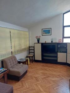 a living room with a couch and a flat screen tv at Apartment Silvana-100m from beach in Božava