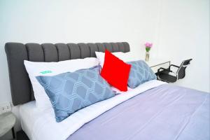 a bed with red and blue pillows on it at Baan Nern Khao Resort Pattaya in Ban Huai Yai +123 photos