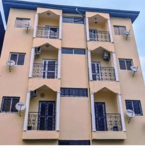 a tall building with windows and balconies at Ladydie House in Douala