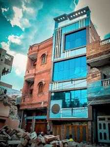 a tall building with glass windows in a city at S A HAVELI GUEST HOUSE in Bikaner