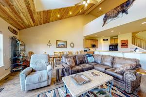 a living room with a couch and two chairs at High Country Haven in Pagosa Springs