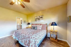 a bedroom with a bed and a lamp on a table at High Country Haven in Pagosa Springs