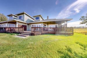 a large house with a large deck on a lawn at High Country Haven in Pagosa Springs