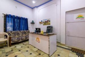 a room with a desk and a podium with a screen at Eastern Gate Homestay in Khajurāho