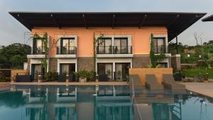 a building with a swimming pool in front of it at East India House in Gorai +16 photos