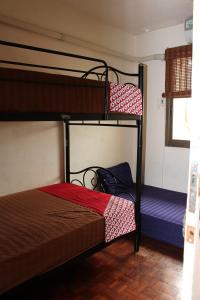 a bedroom with two bunk beds and a window at OYO 985 The Twins Hostel in Bangkok