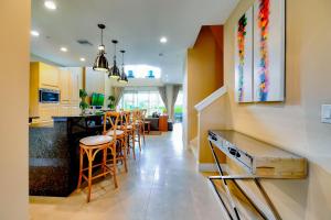 uma cozinha e sala de jantar com um bar e cadeiras em Beautiful Townhome Overlooking The Lake And The Pool em Orlando