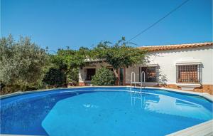 a large blue swimming pool in front of a house at Lovely Home In Jubrique With Wifi in Jubrique