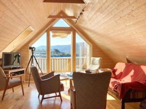 a living room with a large window in a attic at 4 person holiday home in MÅLØY-By Traum in Måløy