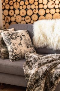 a couch with two pillows and a blanket on it at Apartament pod Wierchem in Zakopane