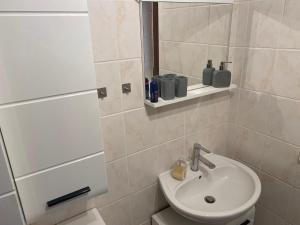 a bathroom with a sink and a mirror at Bungalow im Garten in Wiek in Wiek auf Rügen +5 photos