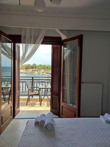 a bedroom with a bed and a view of the ocean at l' atoll d' Helene in Gythio