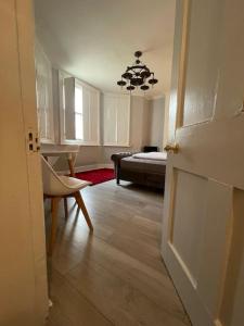a room with a bedroom with a bed and a door at The Vault – cosy apartment in central Hove / Brighton in Brighton & Hove