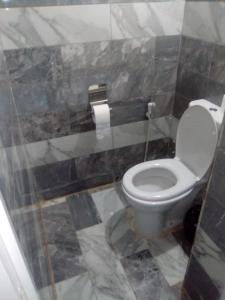 a bathroom with a toilet and a roll of toilet paper at بيت شمس in Aswan +38 photos
