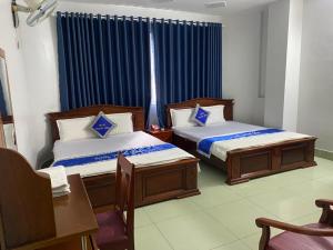 Postel nebo postele na pokoji v ubytování Khách Sạn Thanh Hồng