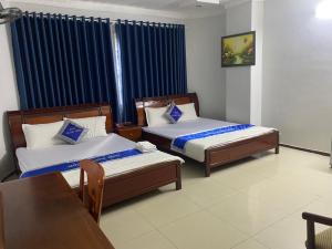 Postel nebo postele na pokoji v ubytování Khách Sạn Thanh Hồng