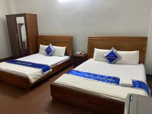 Postel nebo postele na pokoji v ubytování Khách Sạn Thanh Hồng