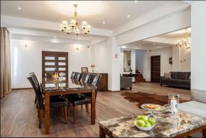 a dining room and living room with a table and chairs at Chalet Belmont in Azuga