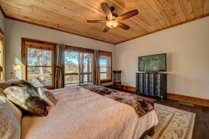 a bedroom with a bed and a ceiling fan at Highland Harmony in Ellijay