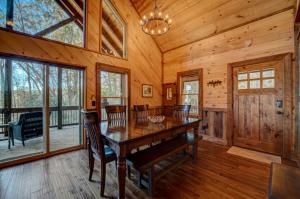 a dining room with a wooden table and chairs at Highland Harmony in Ellijay