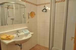 a white bathroom with a sink and a shower at Hansbauerhof in Rattendorf +25 photos