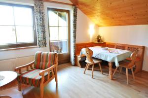 a dining room with a table and a chair at Hansbauerhof in Rattendorf