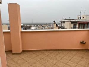 a balcony with a view of a city at Appartamento Minerva in Palo del Colle +3 photos