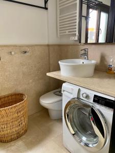 a bathroom with a washing machine and a sink at Heart of Old Town Apartment in Marbella